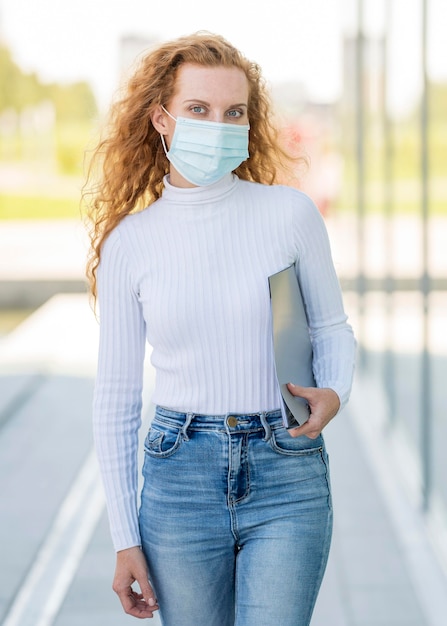 Businesswoman wearing medical mask outdoors