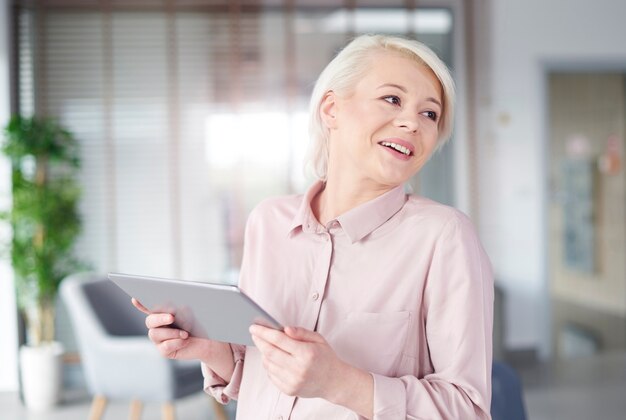 Businesswoman with digital tablet laughing