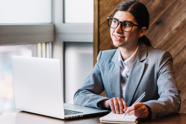 Businesswoman with laptop in coffee shop