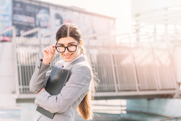 Businesswoman with laptop and smartphone in coffee shop