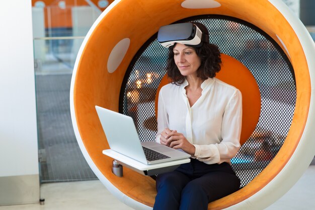 Businesswoman with taken off VR headset