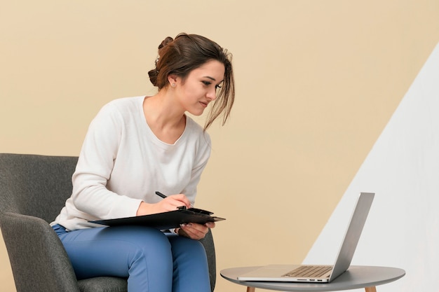 Businesswoman working on a laptop while sitting