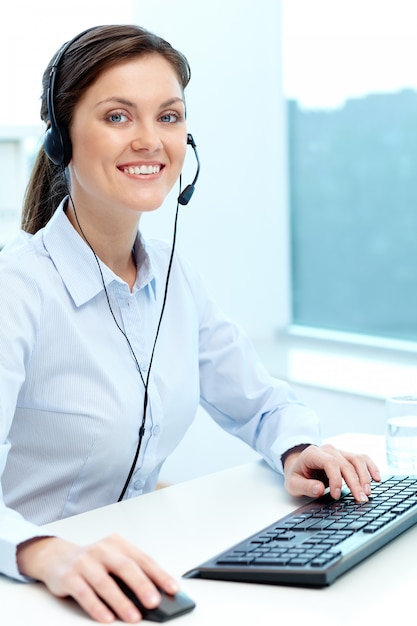 Businesswoman working online with a laptop and headset