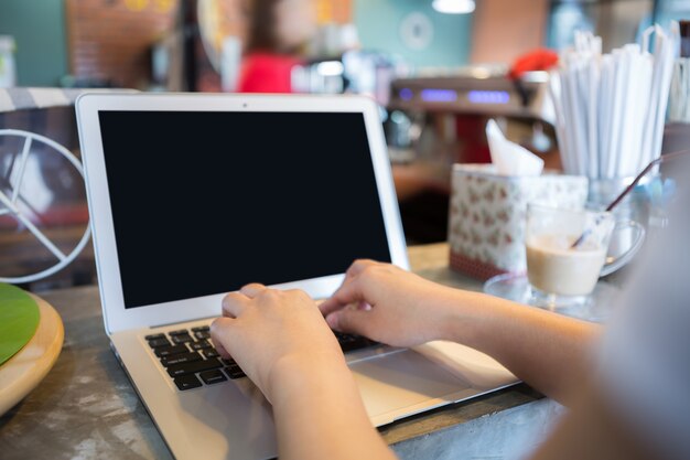 Businesswoman working with laptop close-up