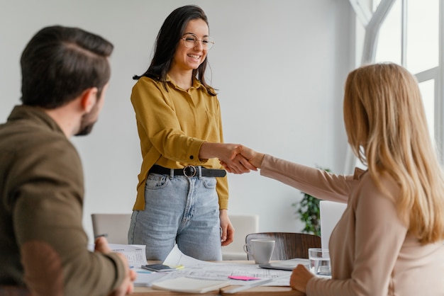 Businesswomen shaking hands at work