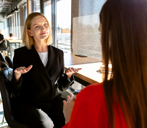 Businesswomen using sign language at work