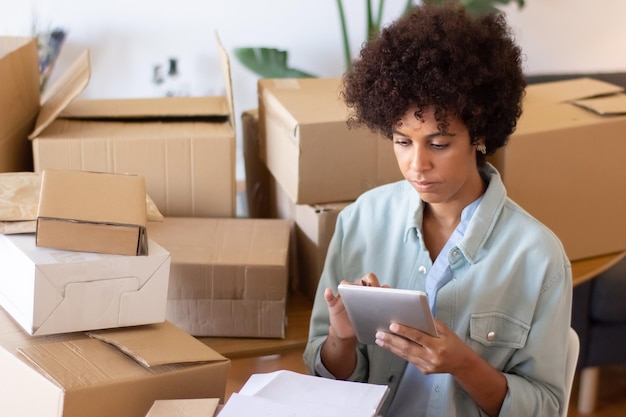 Free photo busy african american woman using tablet