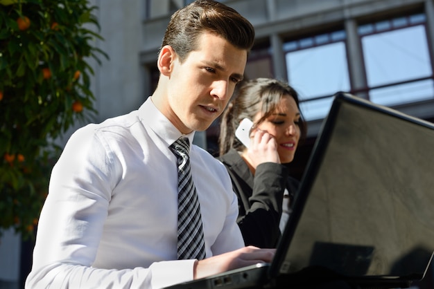 Free photo busy businesspeople working outdoors