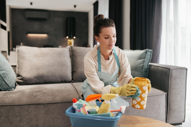 Free photo busy day. young woman doing housework and looking busy