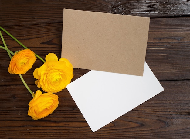 Free photo buttercups flowers and white paper.