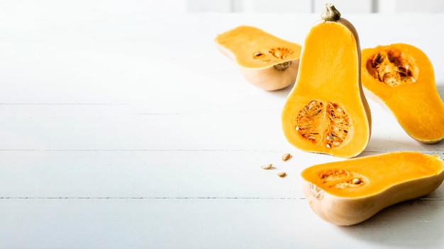 Butternut squash halves on white wooden table