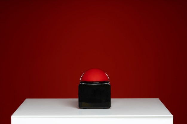 Free photo buzzer on white table with red background