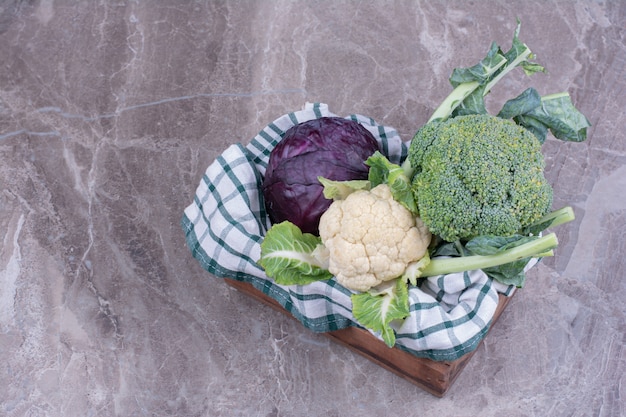 Cabbage and cauliflower on wooden platter.