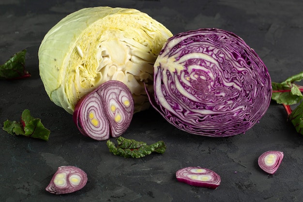 Cabbages colored mellow cabbages and green leafs on grey background