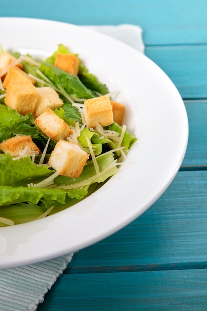 Caesar salad on picnic table close up