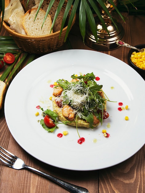 Caesar salad with fresh vegetable and chicken. salad in white plate on wood table, delicious salad 