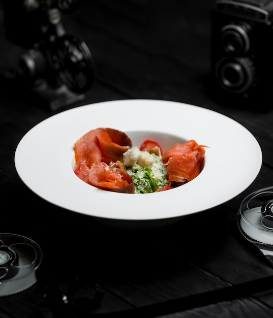 Caesar salad with smoked salmon and crackers