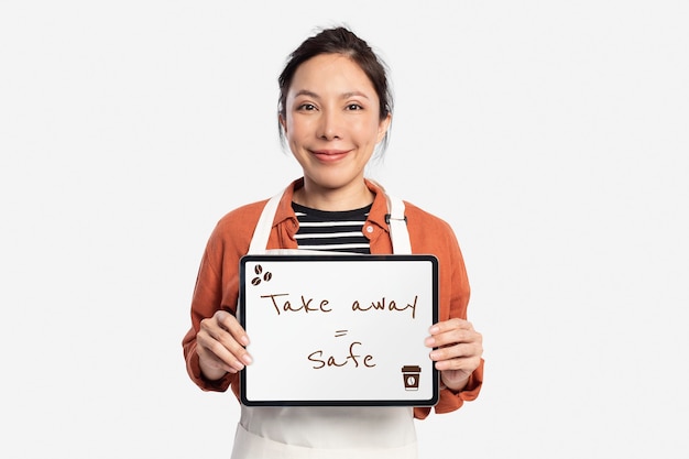 Cafe worker holding tablet with takeaway text