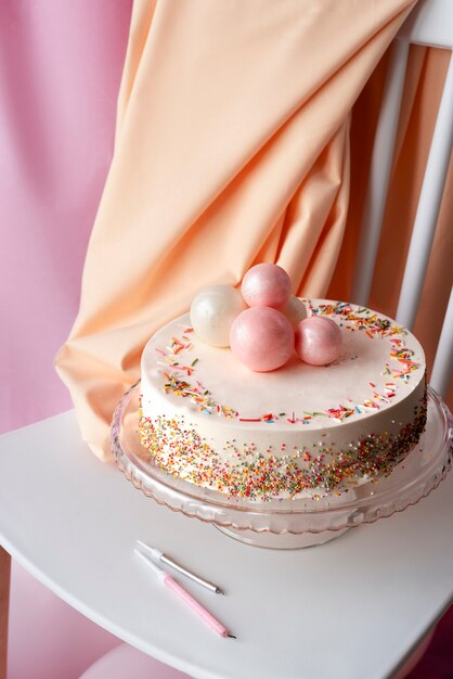 Cake for birthday event on chair with balloons