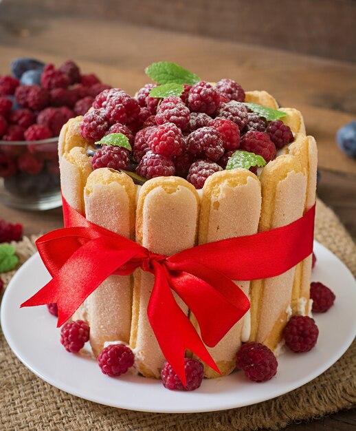 Cake "Charlotte " with raspberries and plums.