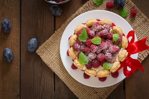 Cake "Charlotte " with raspberries and plums.