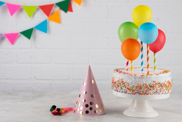 Free photo cake and colorful balloons arrangement