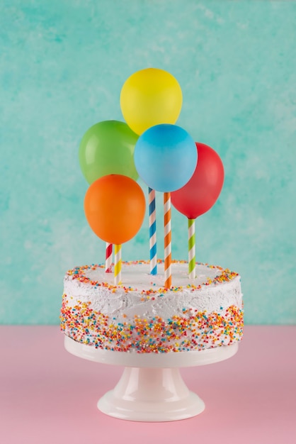 Free photo cake and colorful balloons assortment