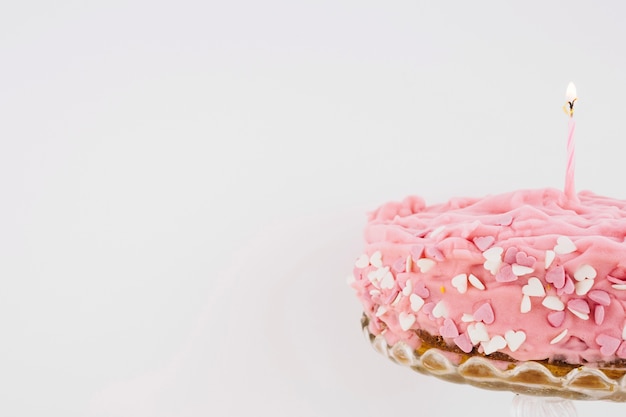 Free photo cake decorated with hearts and candle