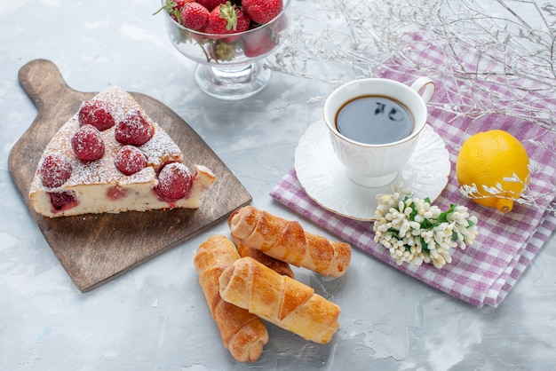 cake slice with fresh red strawberries sweet bangles and coffee on light desk, sweet bake biscuit cookie tea pastry