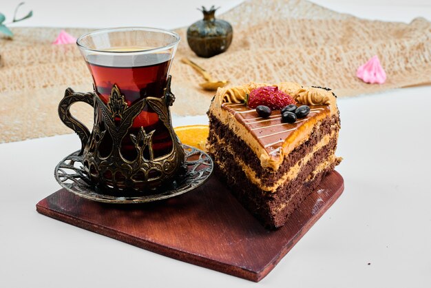 Cake slice with a glass of tea.