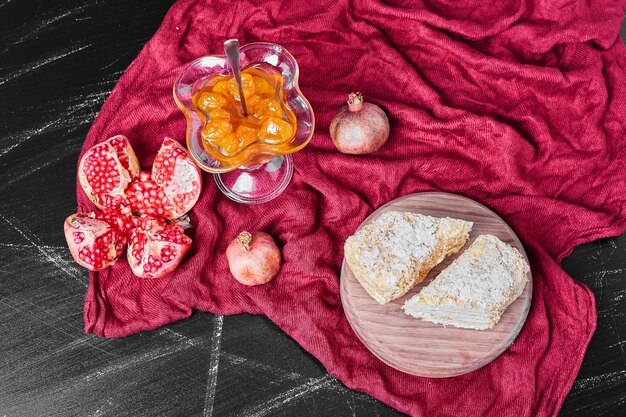 Cake slices and confiture on red towel