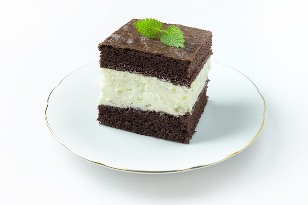 The cake with chocolate and milk filling lies on a white plate