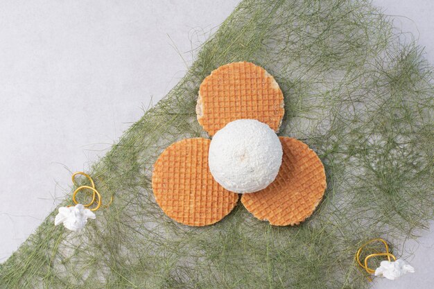 Cake with coconut sprinkles on green surface