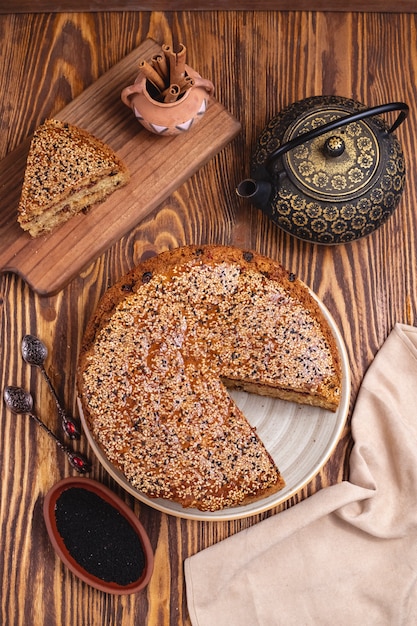 Cake with jam raisin sesame cinnamon tea pot top view