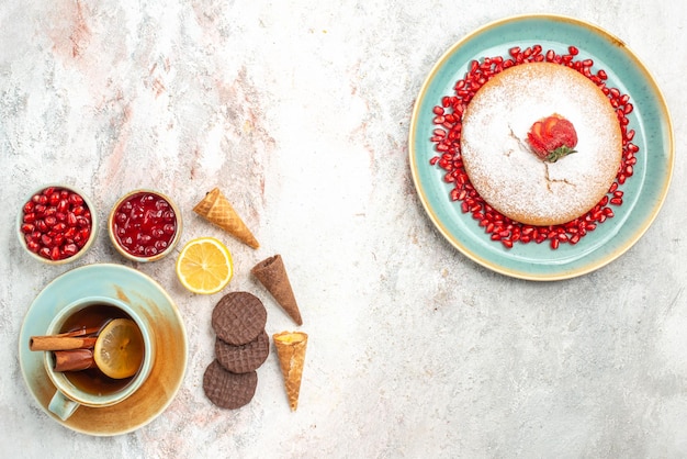 cake with strawberries the cake with pomegranate cinnamon a cup of tea cookies