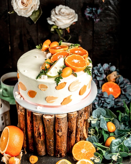 Cake with white cream decorated with lime and orange