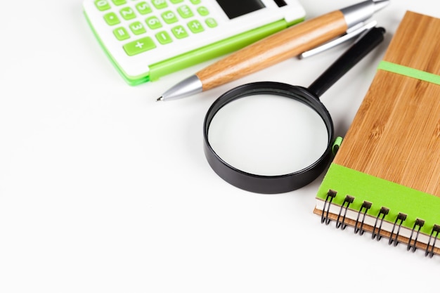 Calculator with a magnifying glass on a white background