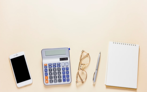 Calculator with smartphone on table