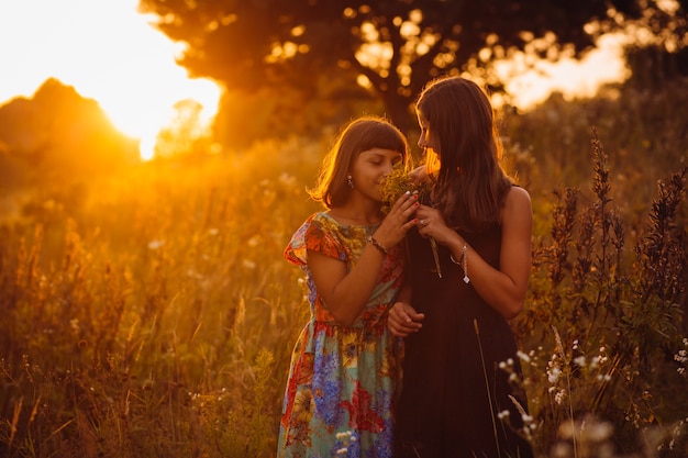 Free photo calm girls stand on the evening field