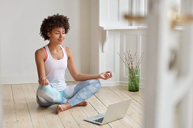 Calm lady with Afro hairstyle, dressed in sportswear