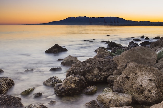 Calm sea covering the rocks