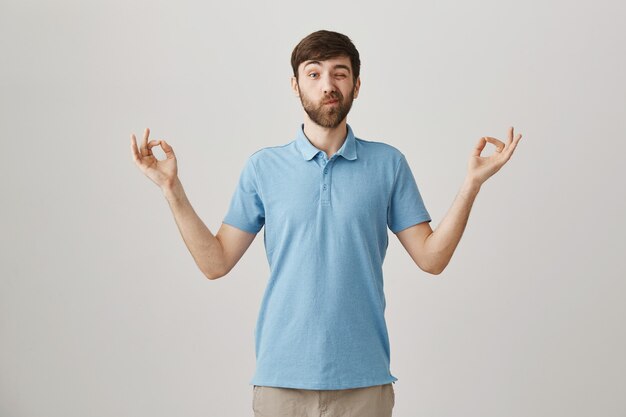 Calm young bearded man posing