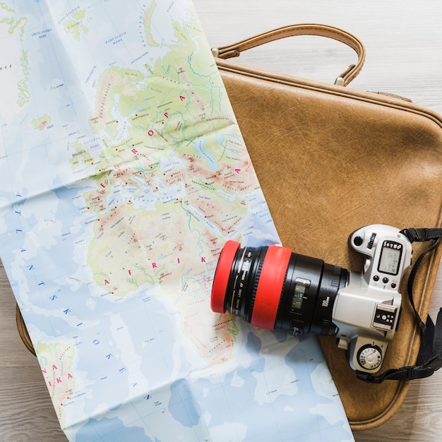 Free Photo camera and map on the travelling bag