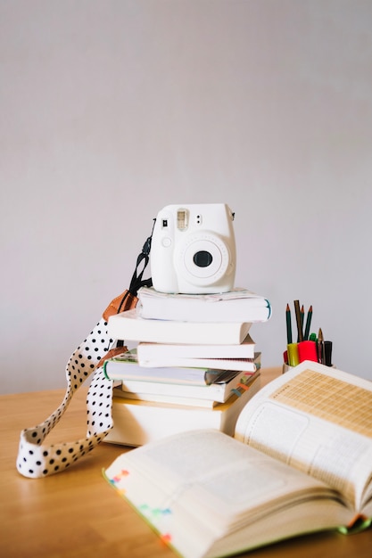 Free Photo camera on pile of notebooks