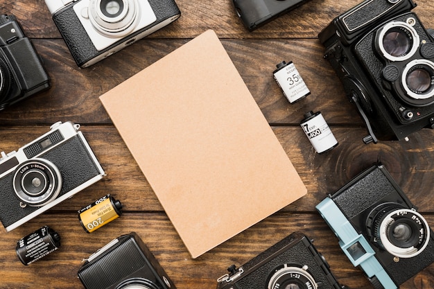 Cameras and cassettes around notepad