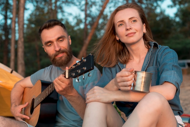 Camping couple enjoying the music