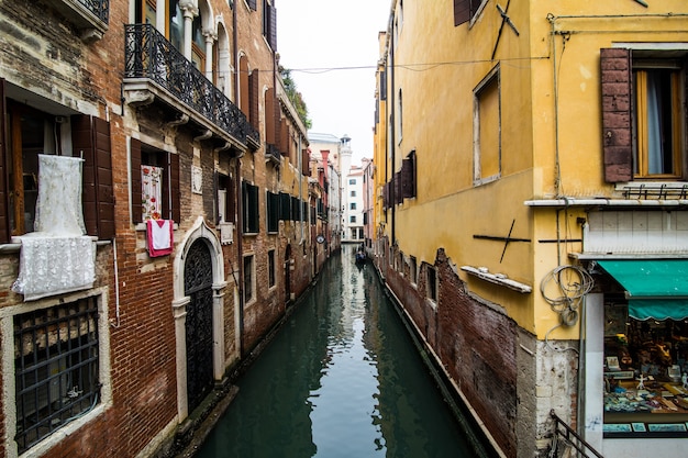 Canal with gondolas in Venice, Italy. Architecture and landmarks of Venice. Venice postcard with Venice gondolas.