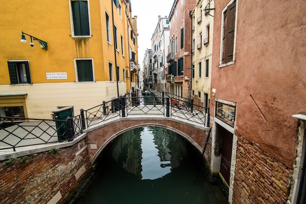 Free photo canal with gondolas in venice, italy. architecture and landmarks of venice. venice postcard with venice gondolas.