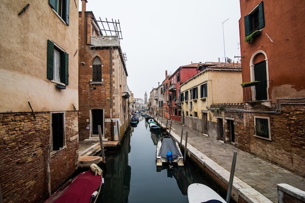 Free photo canal with gondolas in venice, italy. architecture and landmarks of venice. venice postcard with venice gondolas.