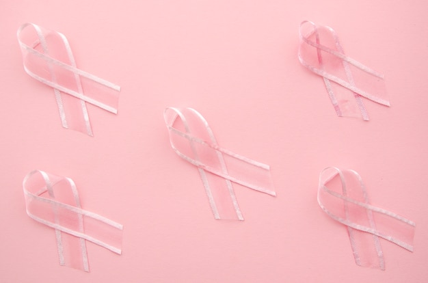 Free photo cancer awareness with ribbons on pink background